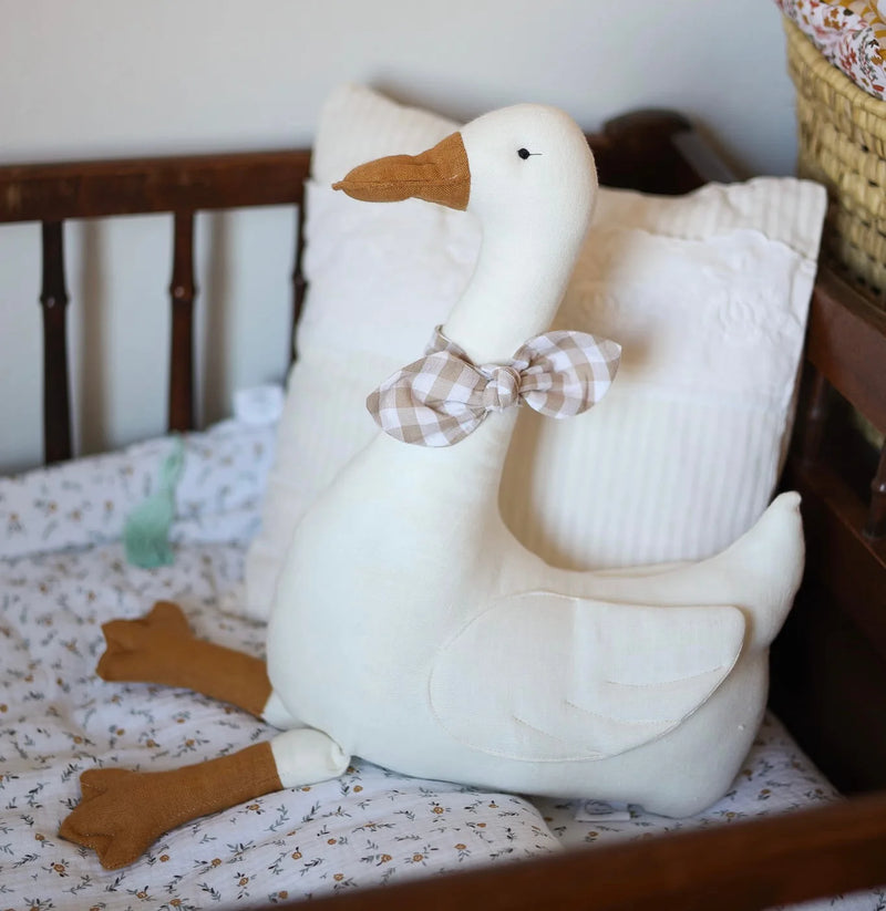 Ganso de Pelúcia Estilo Nórdico para decoração de quarto infantil. Feito de algodão acolchoado, com gravata borboleta xadrez, perfeito para mães e futuras mamães que buscam um toque de charme e sofisticação.